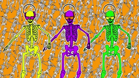 Seamless funny animation of dancing skeletons with headphones in comic style and Video stock 136074902
