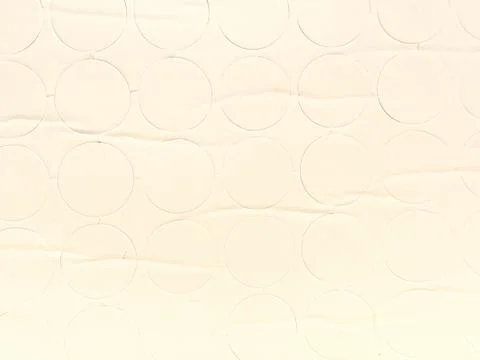 Seamless geometric pattern of beige circular sticker cutouts on textured pape Stock Photos