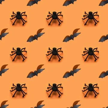 Seamless Halloween pattern of bat on orange background. Fotos de archivo