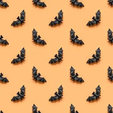Seamless Halloween pattern of bat on orange background. Stock Photos