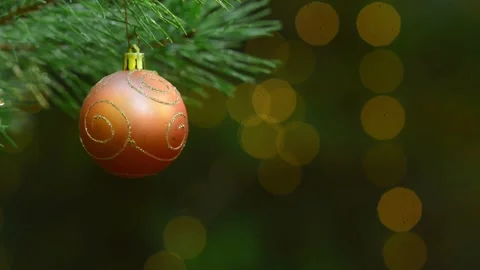 Seamless Holiday Loop with Orange Bauble and Blinking Bokeh Lights Stockbeeldmateriaal 344391408