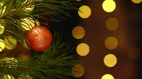 Seamless Holiday Loop with Orange Bauble and Blinking Bokeh Lights Stockbeeldmateriaal 344391503