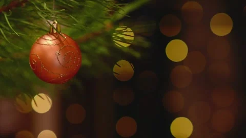Seamless Holiday Loop with Orange Bauble and Blinking Bokeh Lights. Stockbeeldmateriaal 344391516