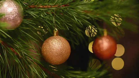 Seamless Holiday Loop with Three Baubles and Blinking Bokeh Lights Stockbeeldmateriaal 344391380