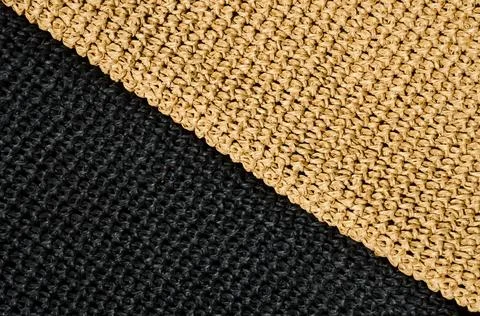 Seamless knitted pattern from black and beige yarn. Hand knitted. Stock Photos