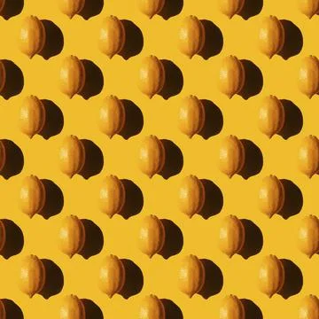 Seamless lemon pattern with a hard shadow on a yellow background 스톡 사진