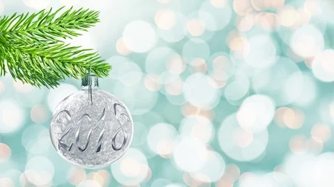 Seamless loop - 2018 on a silver christmas ball hanging from a branch, holida Stock Footage 82640428