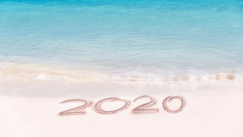 Seamless loop, 2020 written on the sand of a beach, travel 2020 new year concept Video stock 117672260