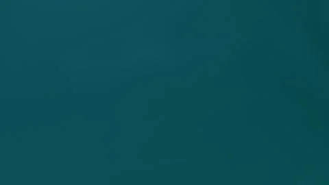 Seamless loop background in 4K with dark teal gradient. Simple, smooth, and Stockbeeldmateriaal 309701387