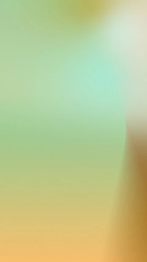 Seamless loop background in 4K featuring a soft gradient of green, yellow, and Vídeos de archivo 309855888