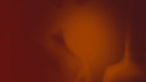 Seamless loop background in 4K featuring a smooth blend of warm red and orange Vídeo Stock 310143485