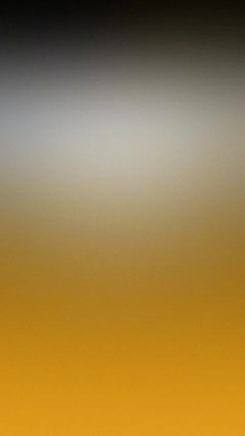 Seamless loop background in 4K. Gradient from yellow to dark blue with grain 動画素材 309701594