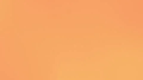 Seamless loop background in 4K. A smooth orange gradient with fine grain texture Video stock 299397342