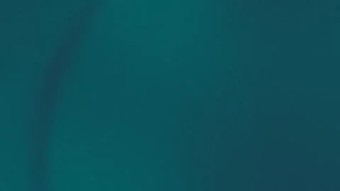 Seamless loop background in 4K with smooth teal gradient. Dark and light hues Stock Footage 299397538