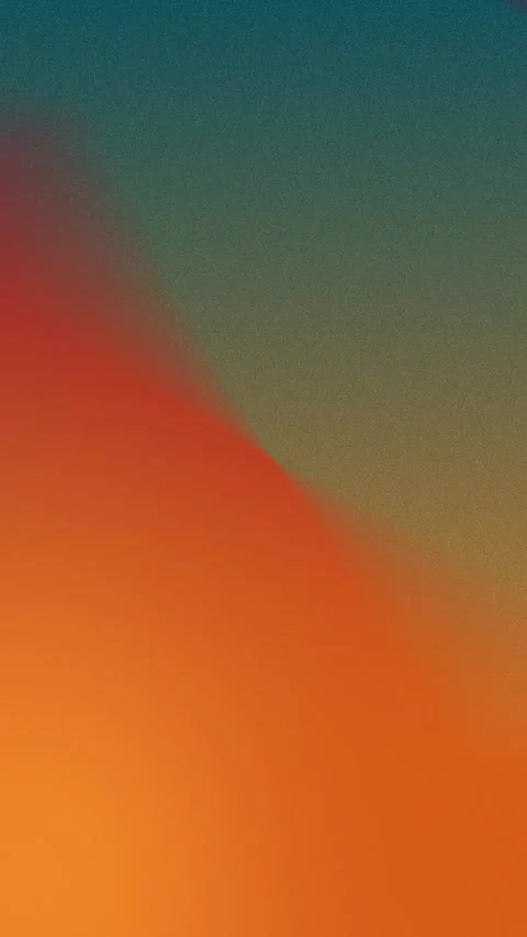 Seamless loop background in 4K. Soft grainy gradient with orange, red, and blue 動画素材 310143455