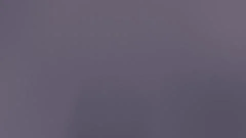 Seamless loop background in 4K with a textured gradient of dark blue and purple Vídeo Stock 309058572