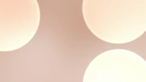 Seamless loop background featuring soft, glowing orbs in warm beige tones Stock Footage 305344756