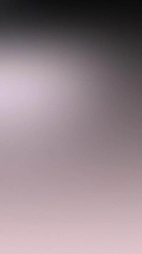 Seamless loop background with gradient from dark gray to soft pink. 4K. Stockbeeldmateriaal 309957052