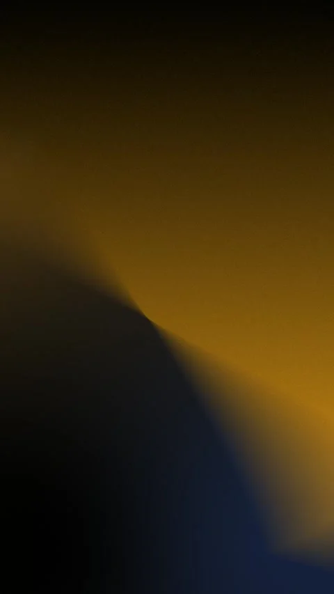 Seamless loop background with gradient hues of deep black and amber. 4K. Vidéo 309701502