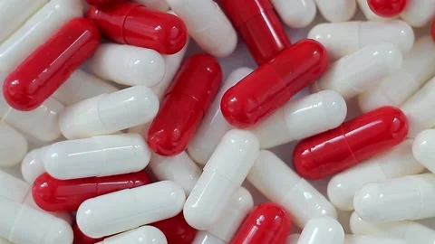 Seamless loop, background, intro. Rotation of red and white capsules, top view. Stock Footage 156298889