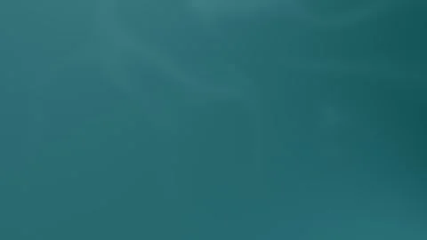 Seamless loop background with smooth teal gradient shades. 4K. Stock Footage 300840527