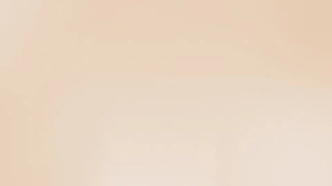 Seamless loop background with a soft beige gradient, subtle texture. Perfect for Stock Footage 299397076