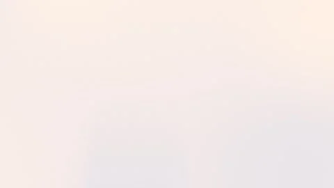 Seamless loop background with soft beige gradient and subtle grain texture. 4K Stock Footage 299397250