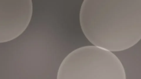 Seamless loop background with soft brown, circular shapes on a muted grey Vídeo Stock 310143409