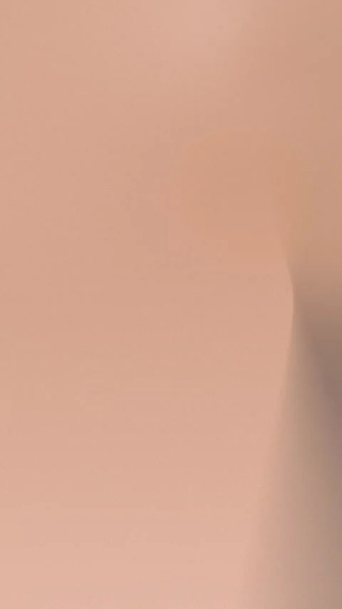 Seamless loop background with soft, muted peach gradient and subtle corner Vídeo Stock 309956390