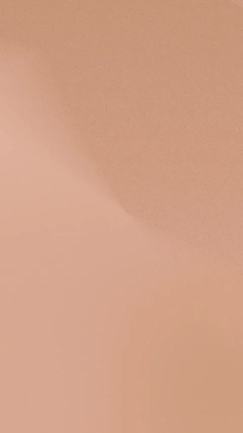 Seamless loop background with soft peach gradient and sandy texture, 4K. Stock Footage 309956504