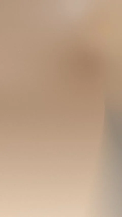 Seamless loop background with soft sand-colored gradient and smooth texture. 4K. Stock Footage 310143428