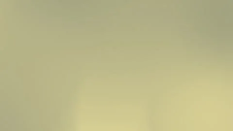 Seamless loop background in soft yellow gradient with fine grain texture. 4K. Vídeo Stock 309955680