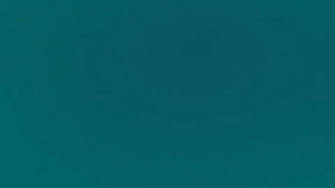 Seamless loop background with teal grainy texture. 4K quality. Stock Footage 300840391