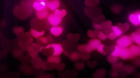 Seamless loop background with valentines hearts flying against light on black Stock Footage 256045694