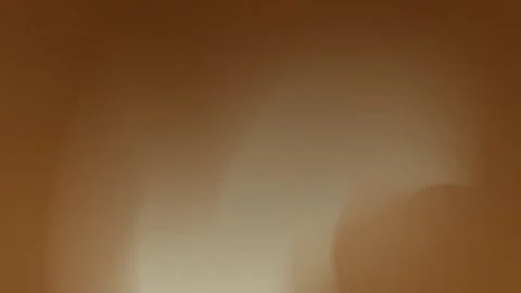 Seamless loop background with a warm brown gradient featuring soft, rounded Stock Footage 299664642