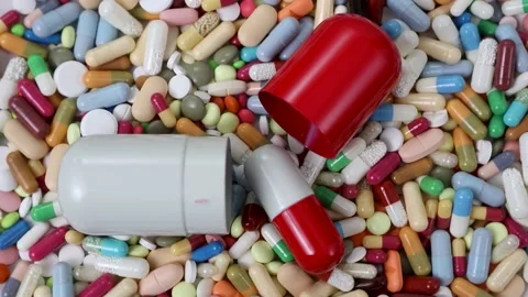 Seamless loop of bigger pills on pile of medication Stock Footage 156043113