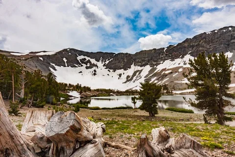 Seamless loop of billowing clouds over ridge and alpine lake Stock Footage 115223480