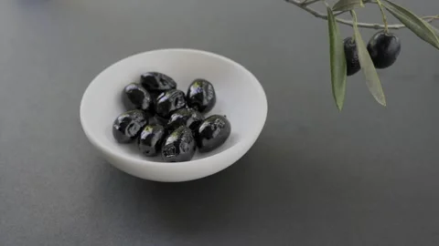 Seamless loop of black olives in white bowl dark background 4k 스톡 동영상 340529523