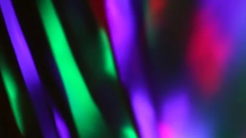 Seamless loop of blurred rotating colorful LED lights and moving hand shadow Stock Footage 127024669