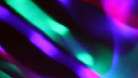 Seamless loop of blurred rotating colorful LED lights and moving hand shadow Stock Footage 127025650