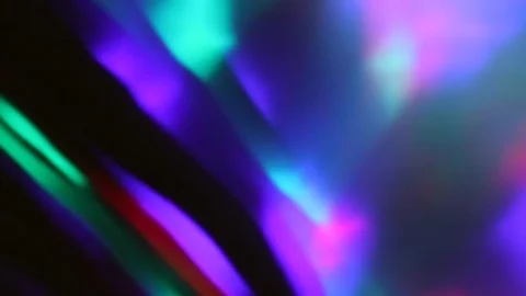 Seamless loop of blurred rotating colorful LED lights and moving hand shadow Stock Footage 127025892