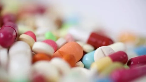 Seamless loop of closeup rotating pile of medicine pills Stock Footage 156043038
