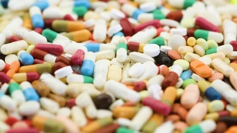 Seamless loop of colorful medication pills spinning Stock Footage 95476660
