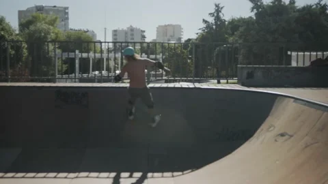 Seamless loop of cool millennial skater ride side of bowl. 4K Stock Footage 220559057