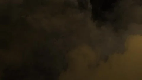 Seamless loop dark golden smoke clouds moving in a slow motion Stock Footage 348271112