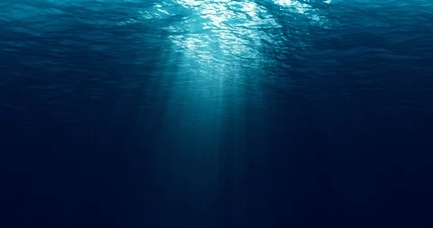 Seamless loop of deep blue ocean waves from underwater background, light rays Stock Footage