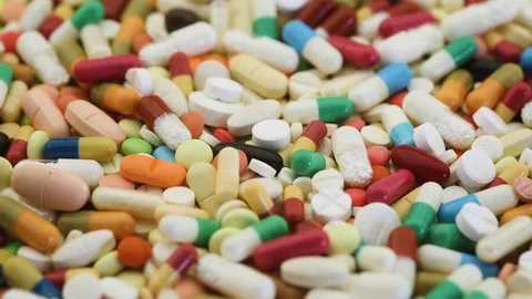 Seamless loop of different pills for medication spinning Stock Footage 95476811