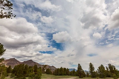 Seamless loop of gathering storm clouds over alpine scene Stock Footage 115202558