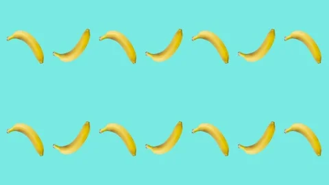 Seamless loop pattern with Bananas on a pale blue background. Exotic fruits Stock Footage 221992003