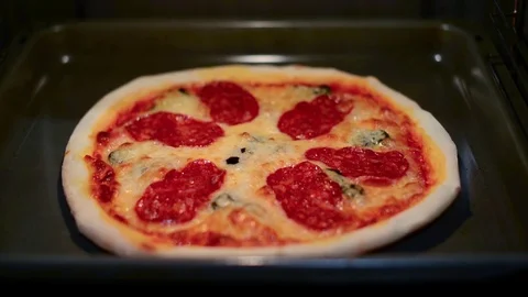Seamless loop - Peperoni pizza baking in the oven Stock Footage 73230435